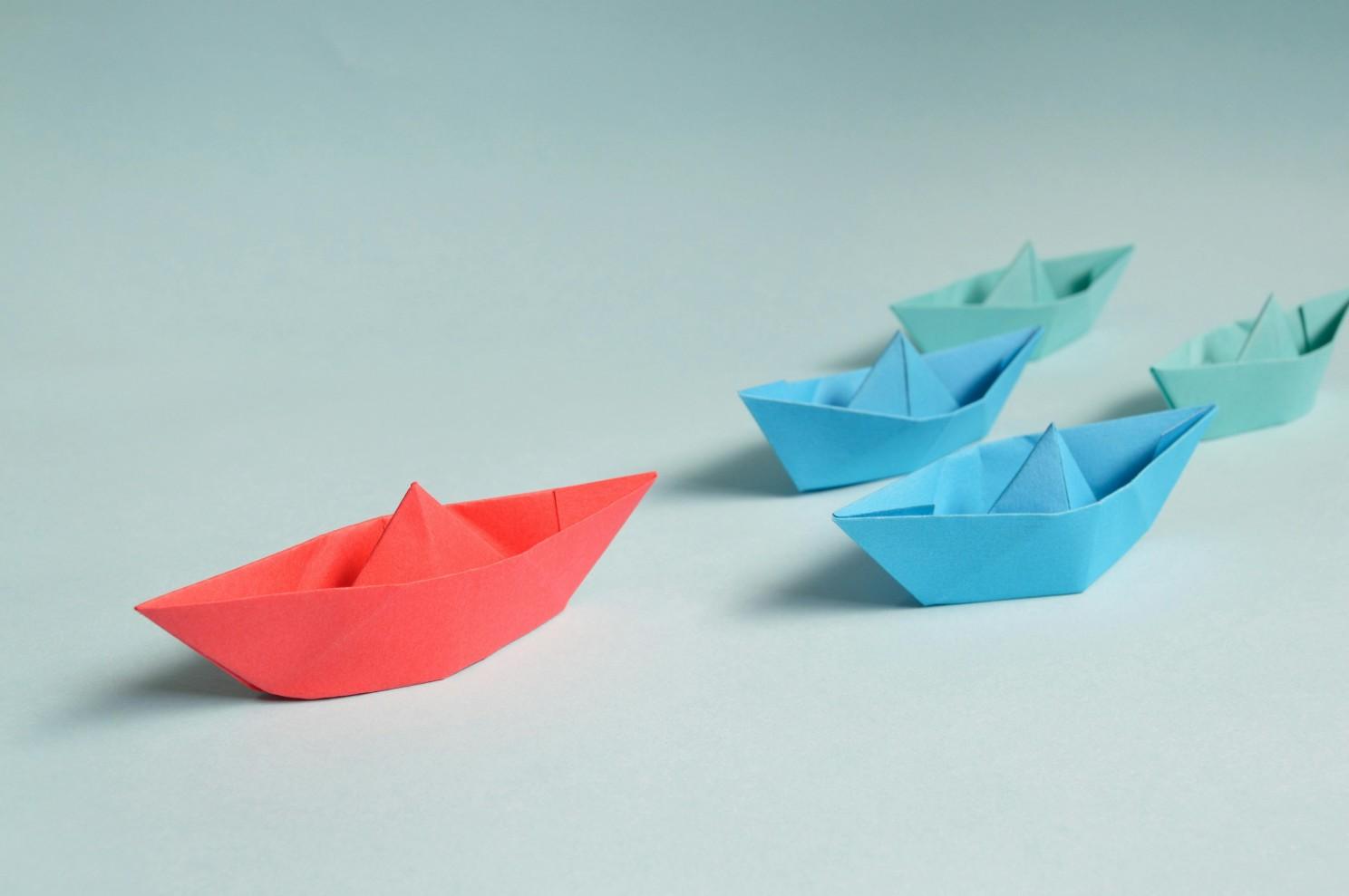 A row of paper boats

Description automatically generated