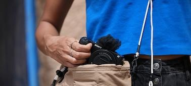 Usage image of a man taking the camera out of a bag