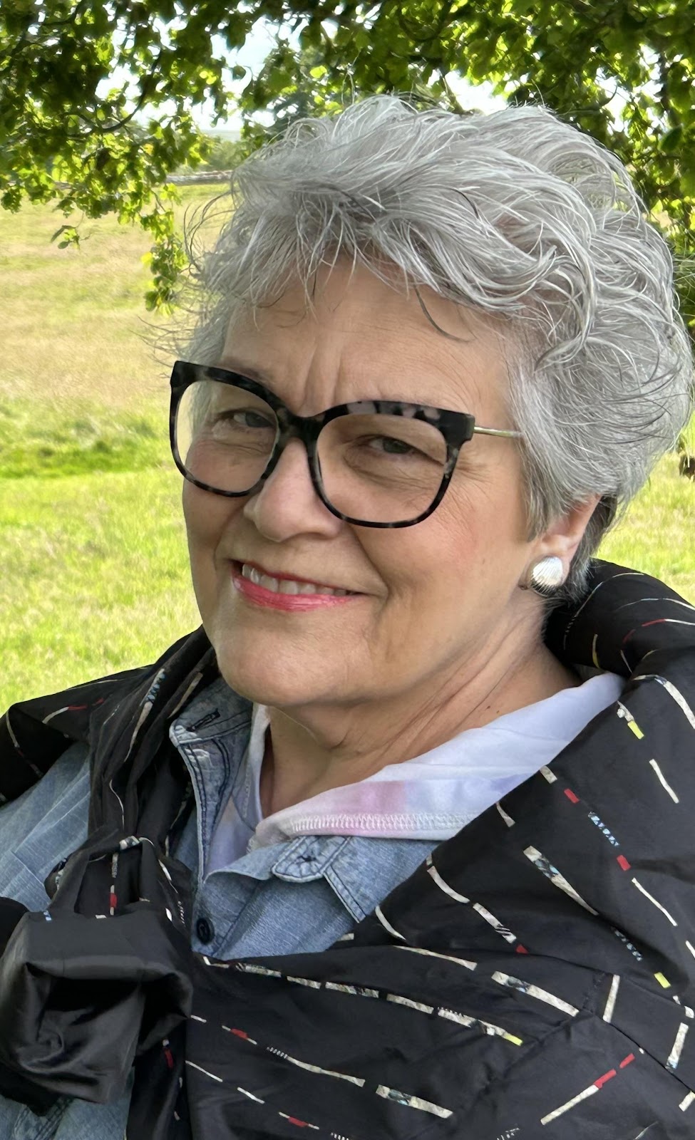 A person smiling at the camera

Description automatically generated