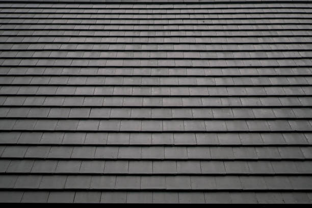 Gray asphalt shingles, durable roofing material, clean lines, weather-resistant design. -tile roof cost