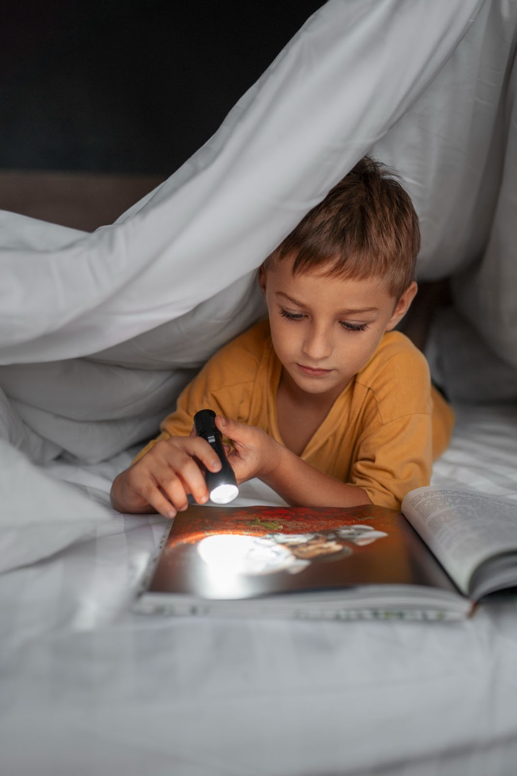 Child using a flashlight for flashcards