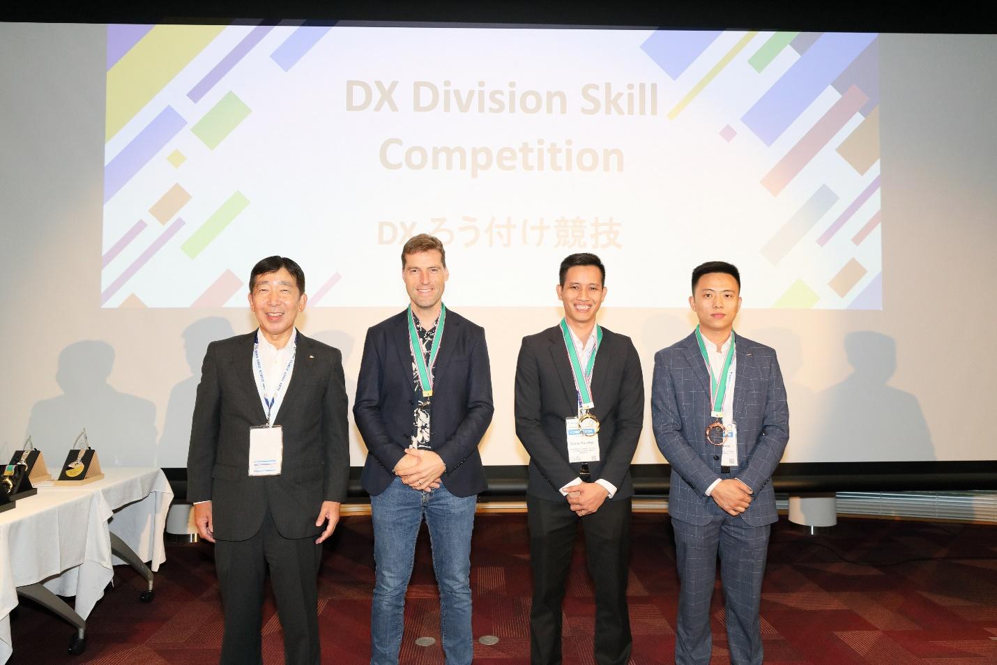 A group of men standing in front of a projector screenDescription automatically generated