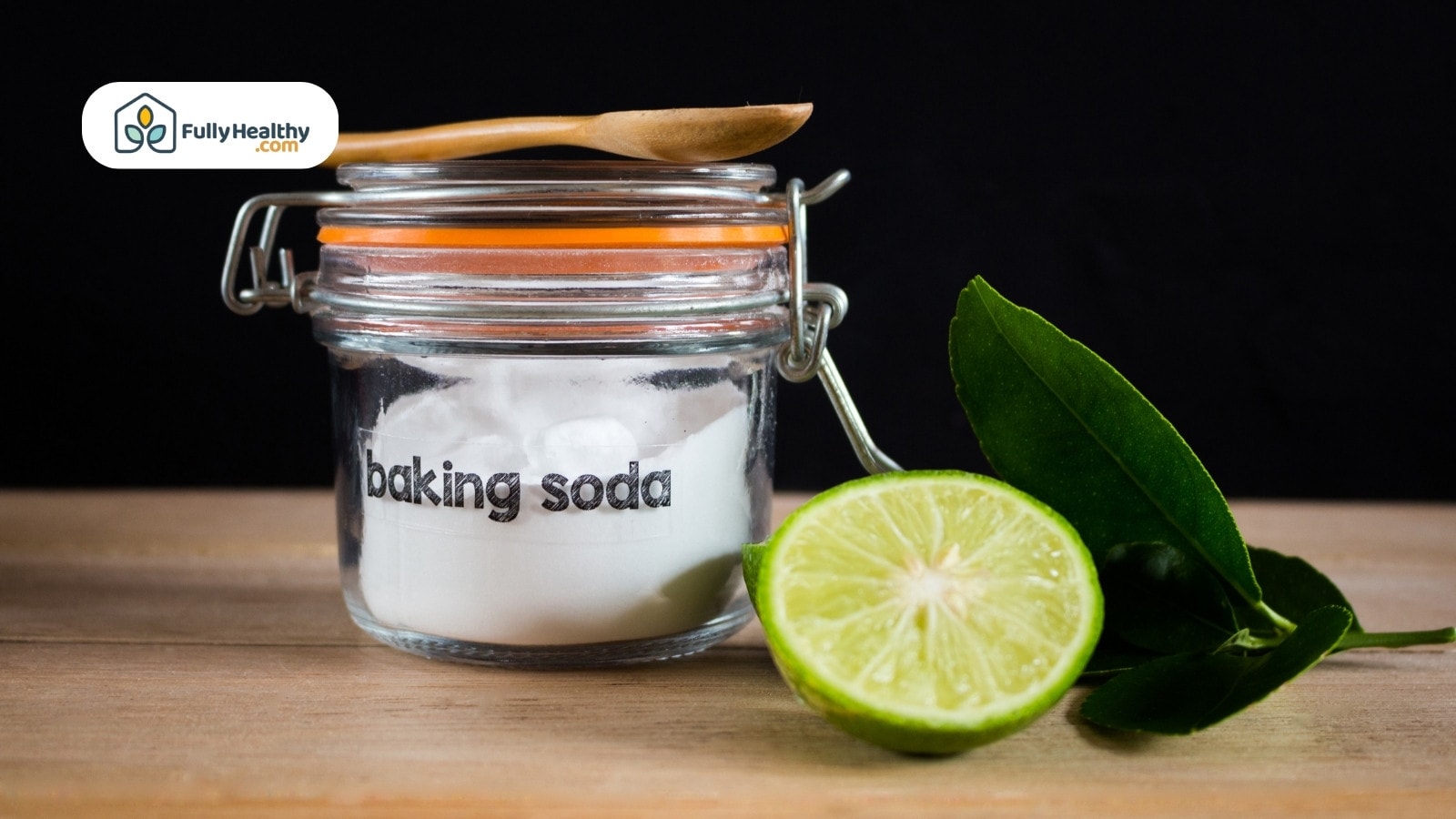 Jar labeled baking soda with lime and leaves on wooden surface