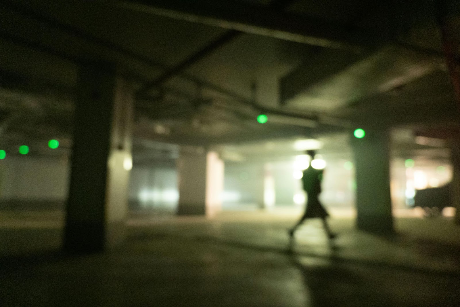 A woman walking in a dark parking lot