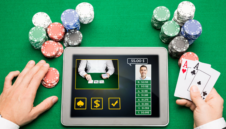 An individual playing online poker on a tablet, holding a pair of aces while the screen displays a live dealer and betting options. The scene is set on a green casino table with stacked chips surrounding the tablet, illustrating a mobile casino gambling environment.for gambling addiction preference