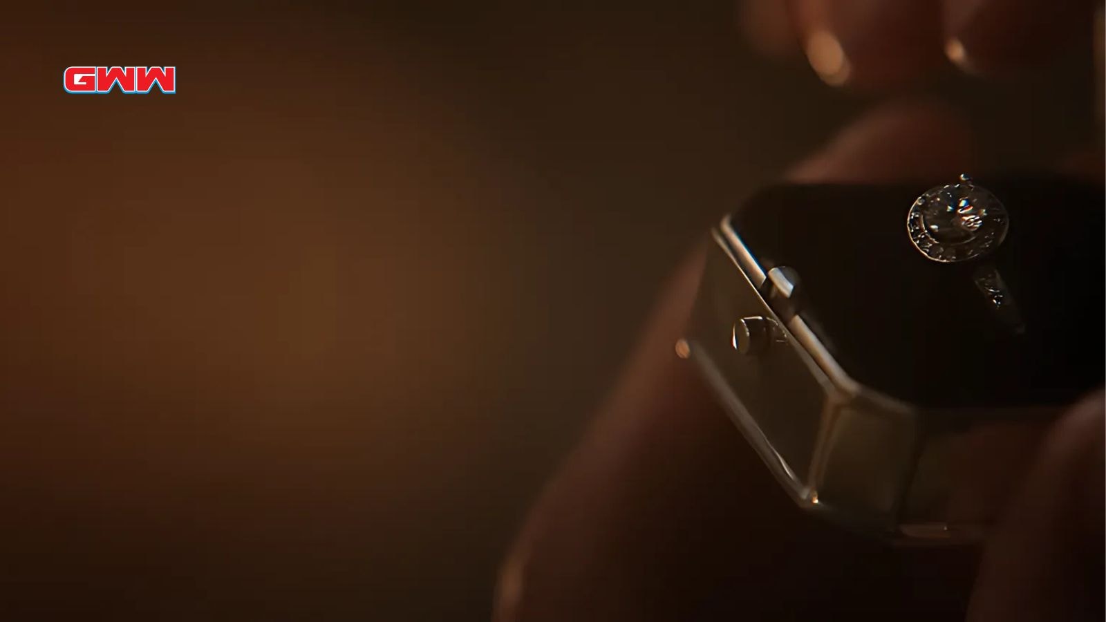 A close-up of an engagement ring box being held under dim lighting