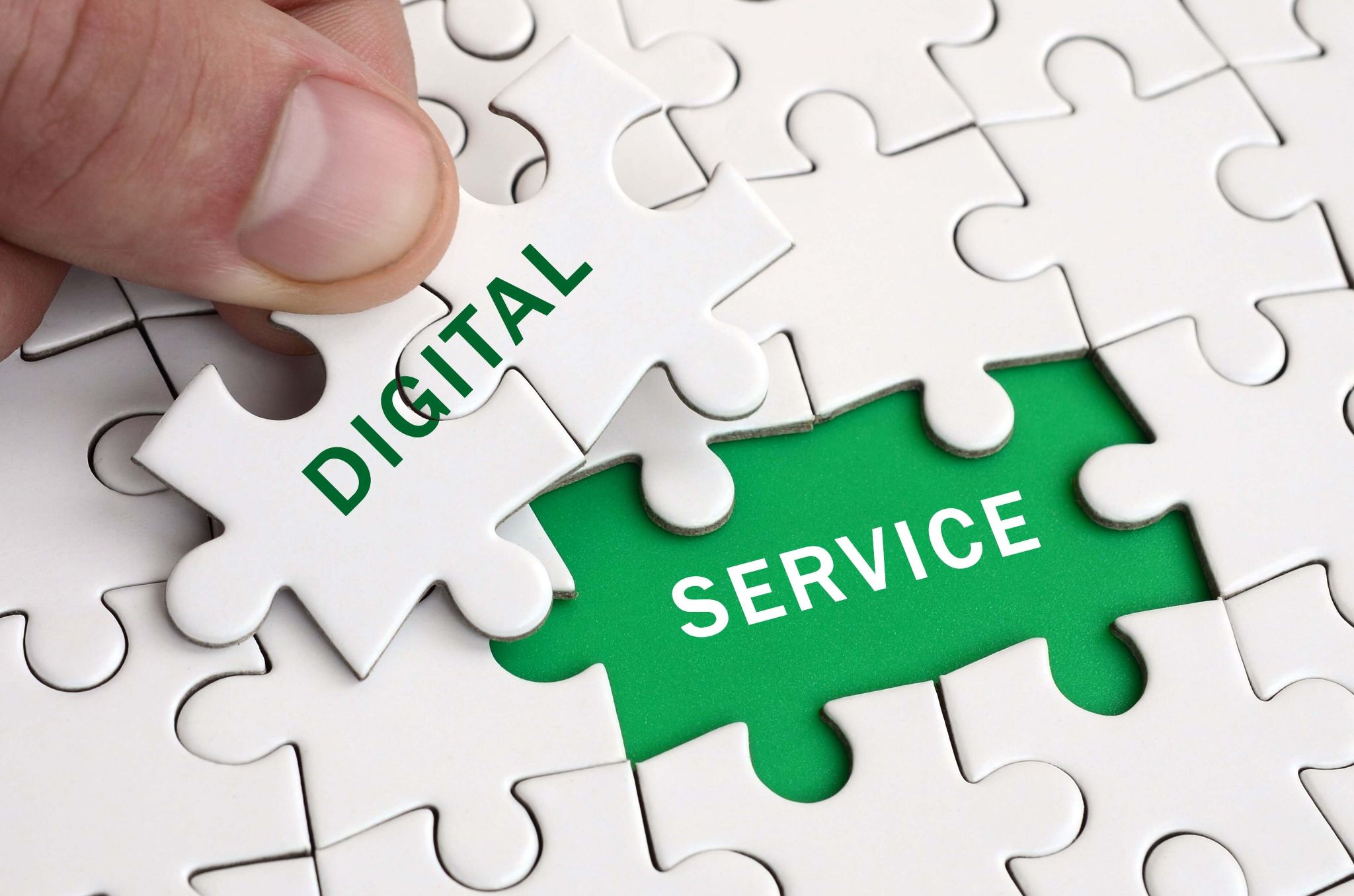 Hand placing a puzzle piece labeled "DIGITAL" to complete "DIGITAL SERVICE."