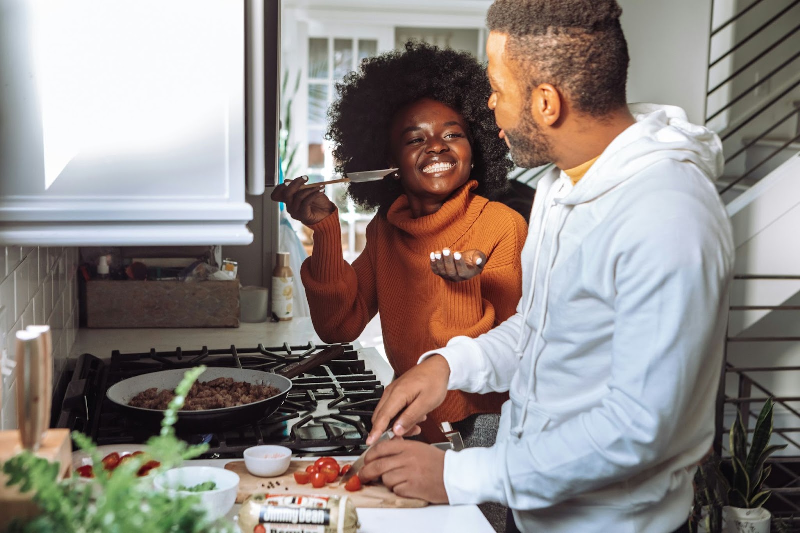 one man and one women cooking together
