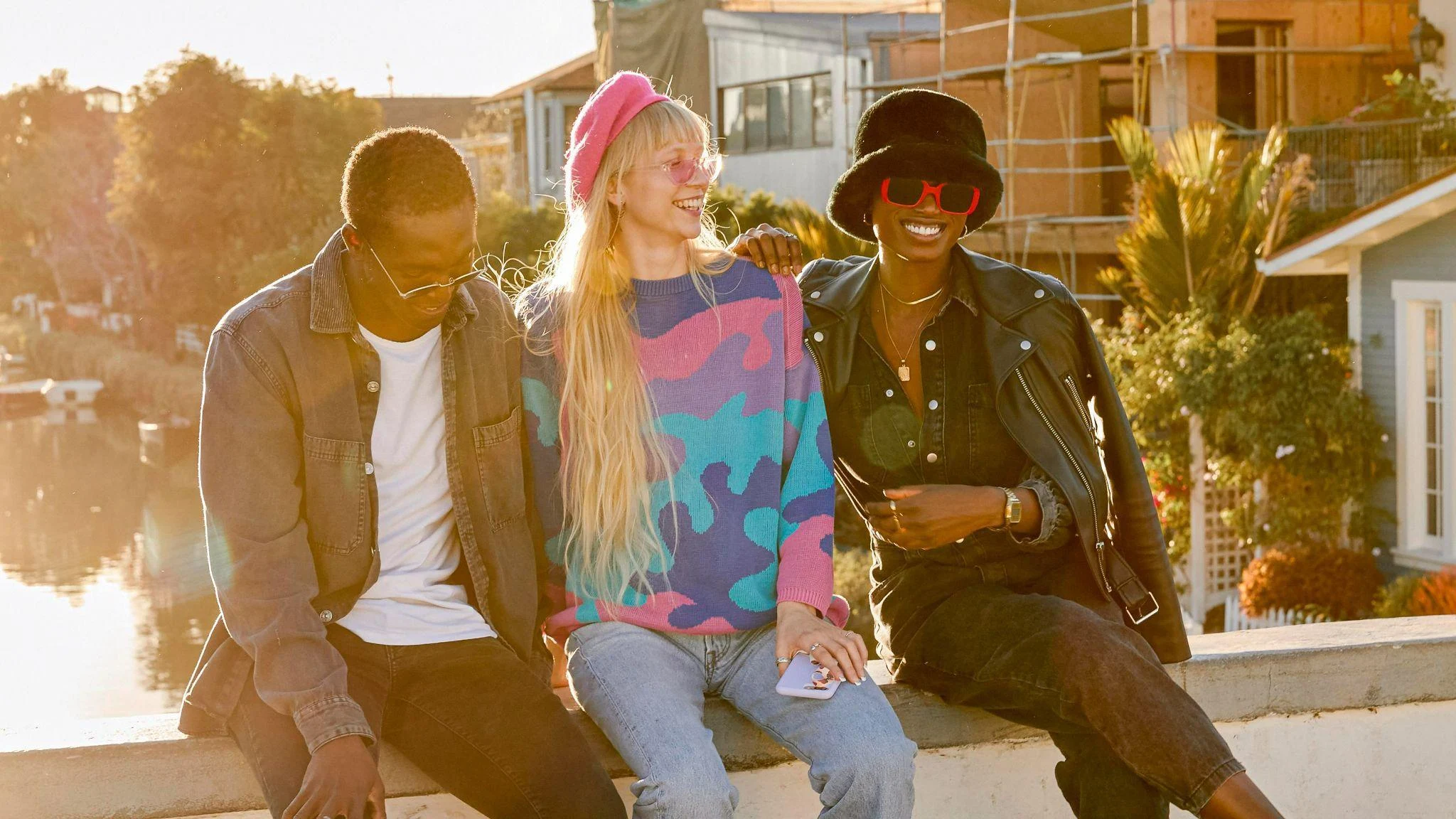 three friends in maximalist fashion sitting together