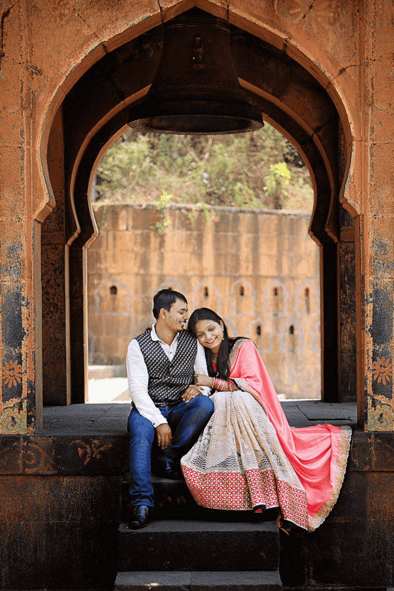 pre wedding shoot of a couple sitting in Ram Bagh Garden happy and smiling.