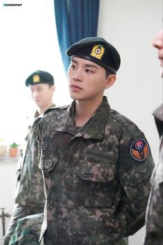 This contains an image of kim wooseok military enlistment 