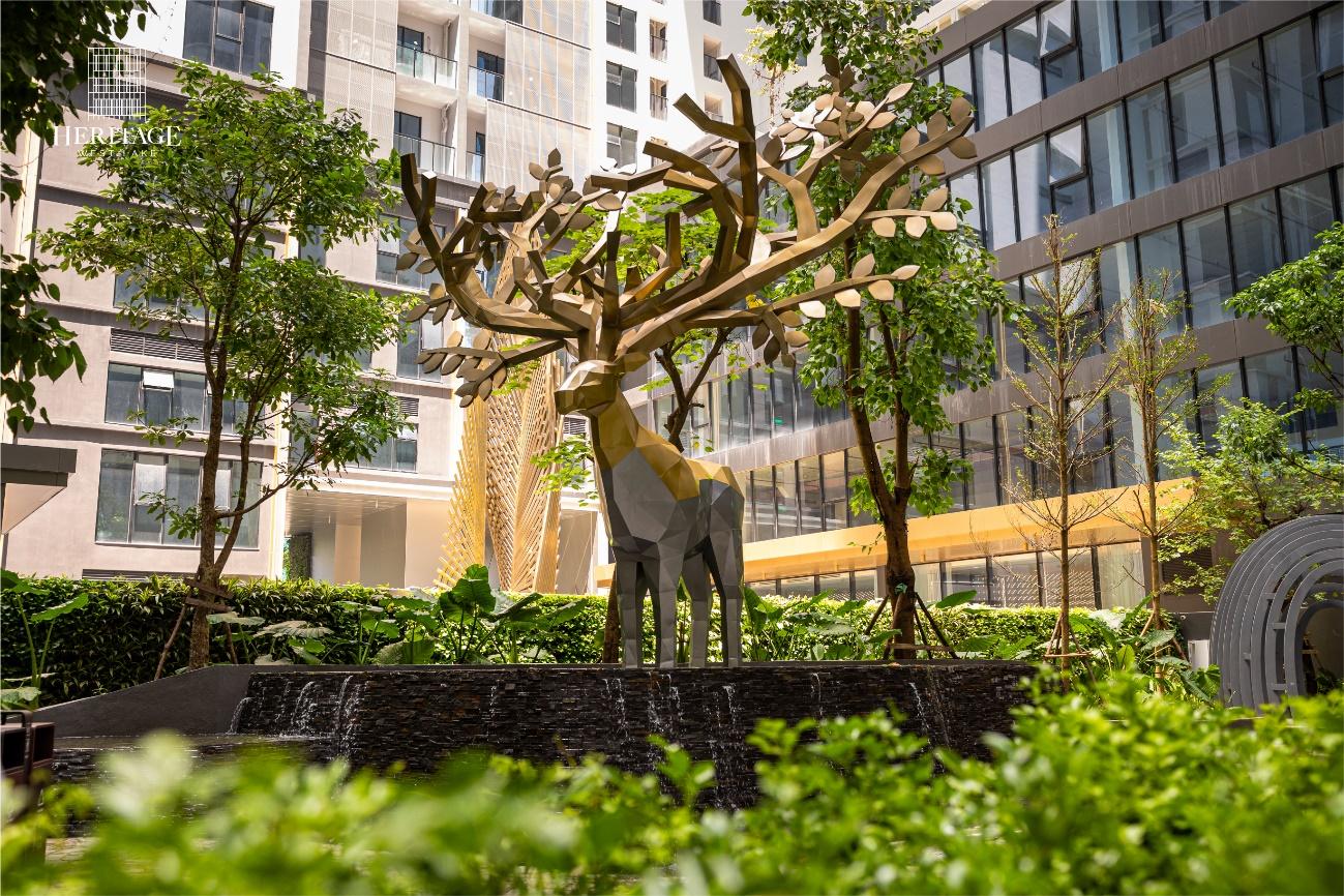 A statue of a deer in a courtyard

Description automatically generated