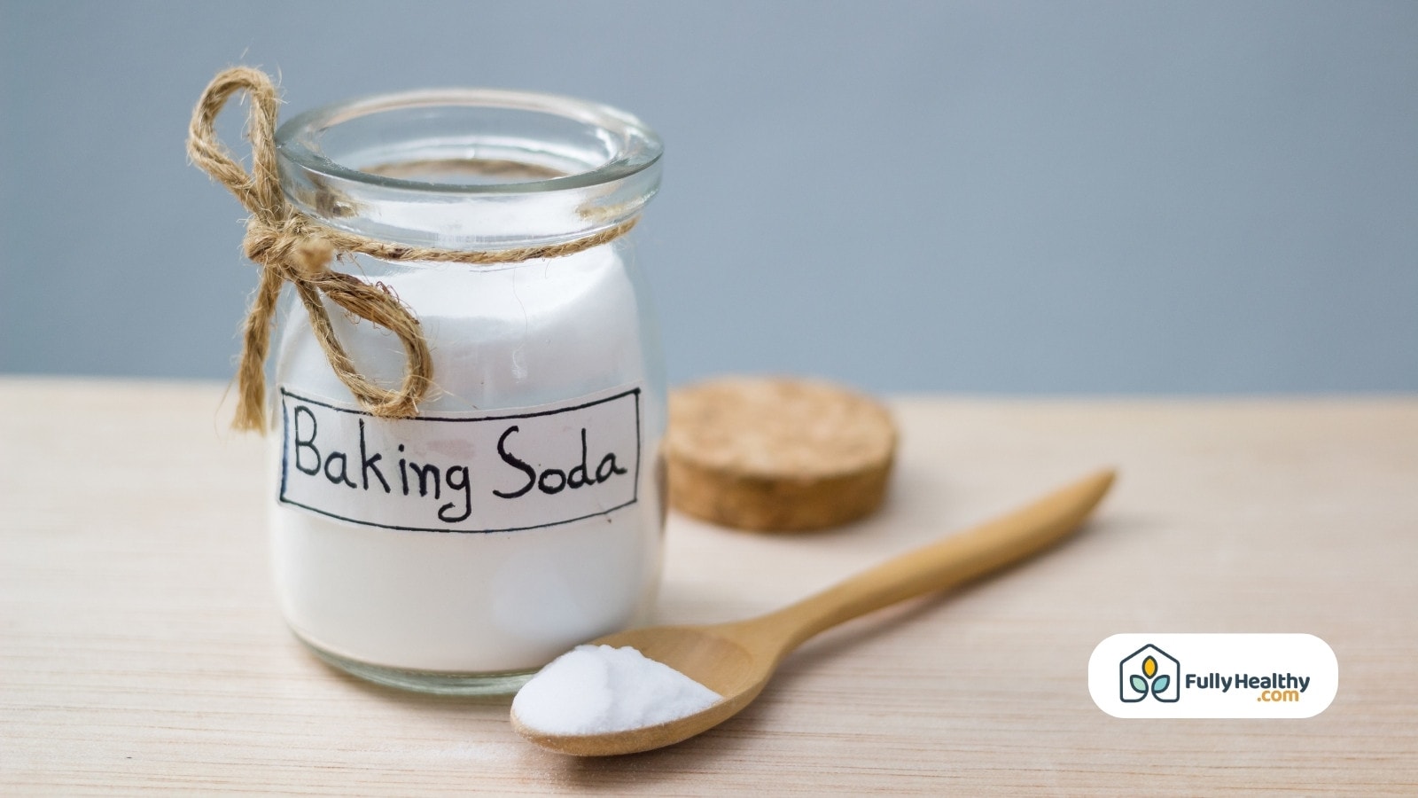 Jar of baking soda with wooden spoon