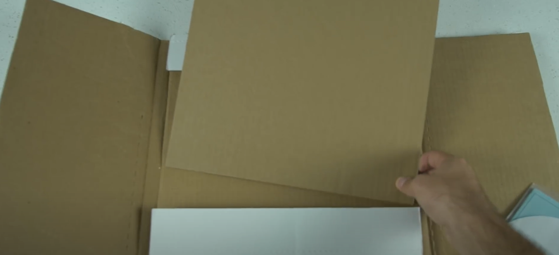 Preparing a sturdy cardboard box with protective layers 