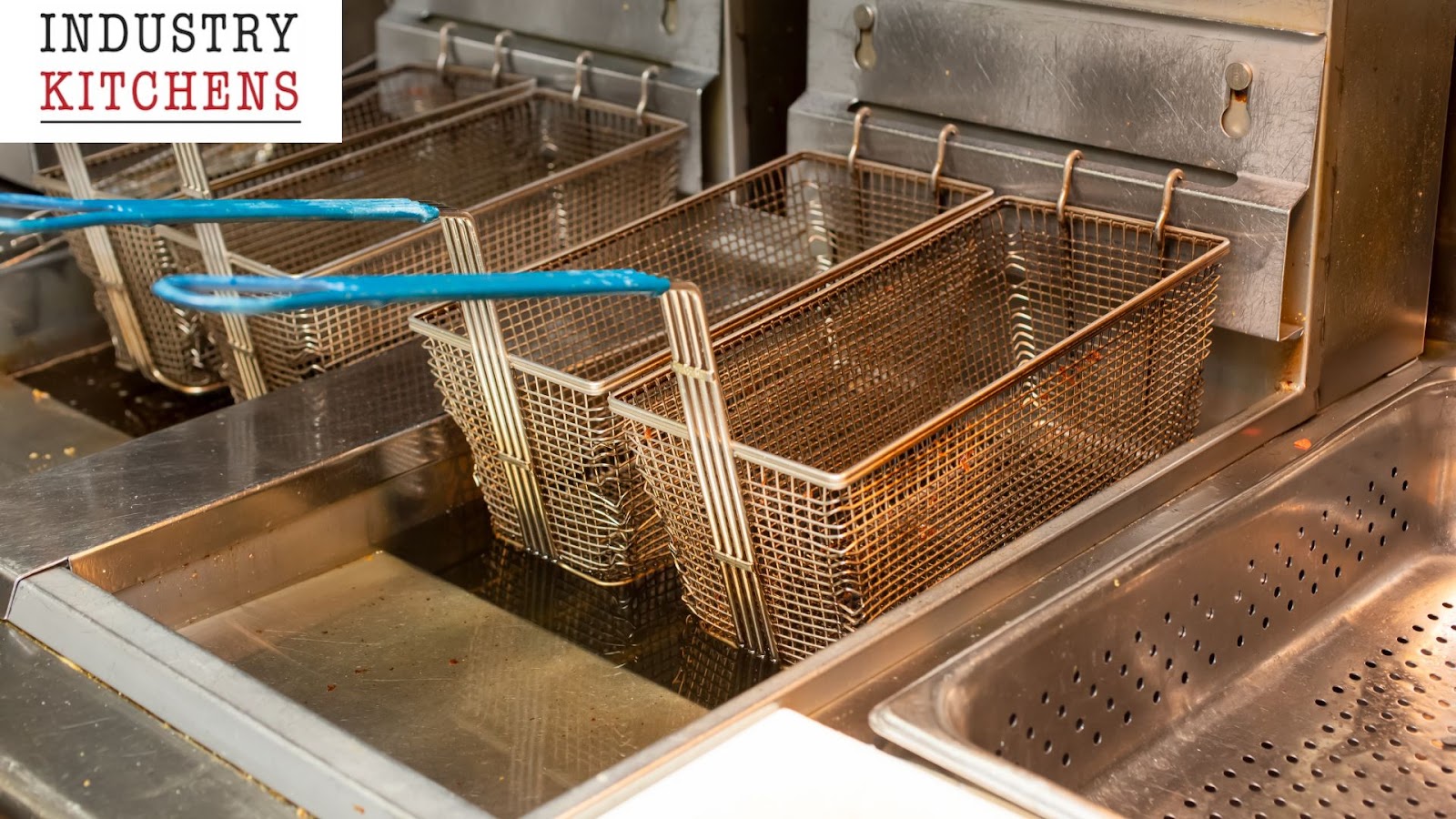 Commercial deep fryer in use in a professional kitchen.