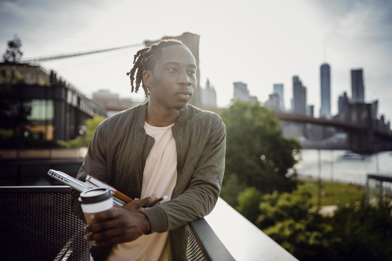 A man relaxes with a coffee and a book, surrounded by the vibrant energy of the city.