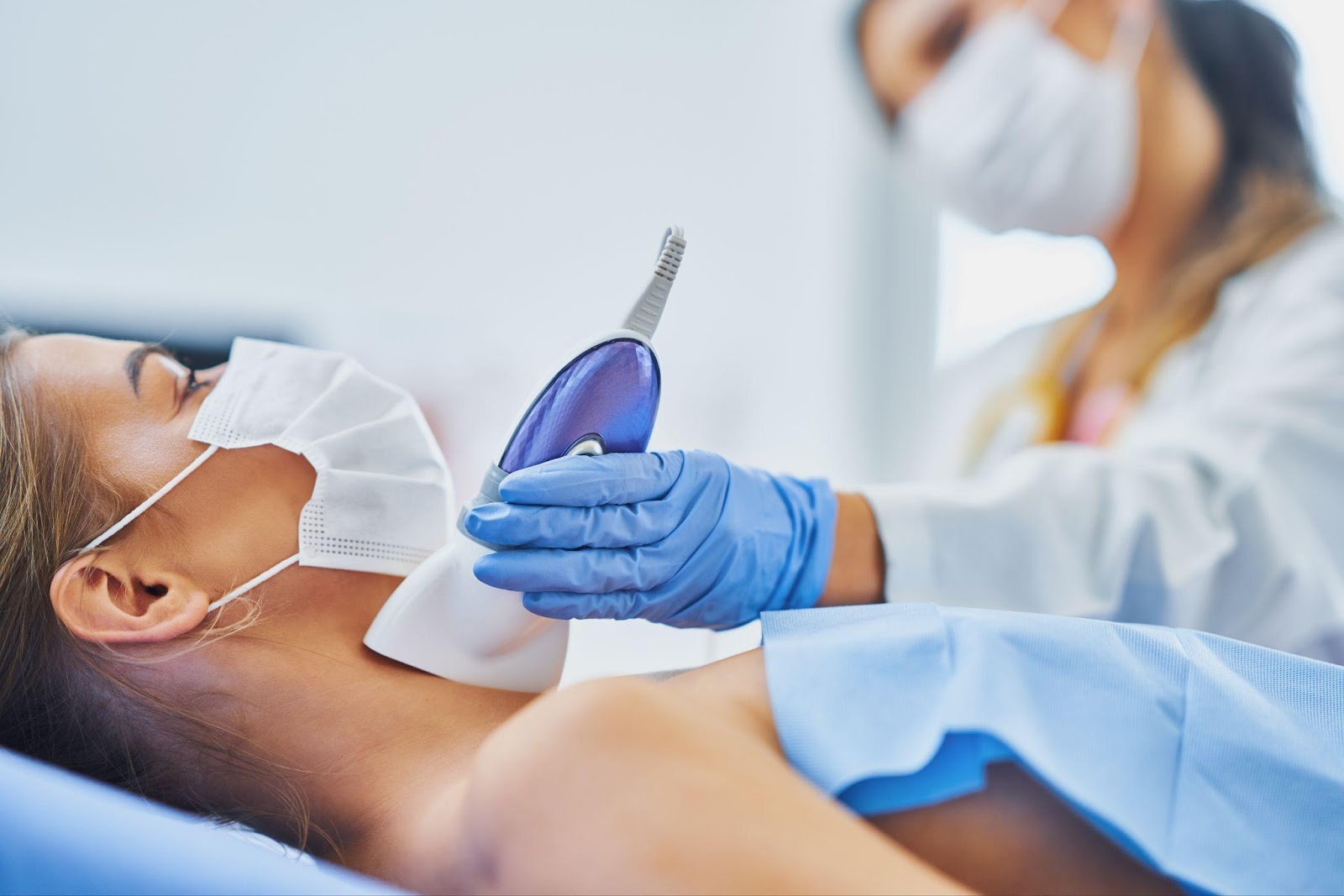 Woman undergoing laser hair removal on her neck, demonstrating the precision and effectiveness of modern hair removal technology
