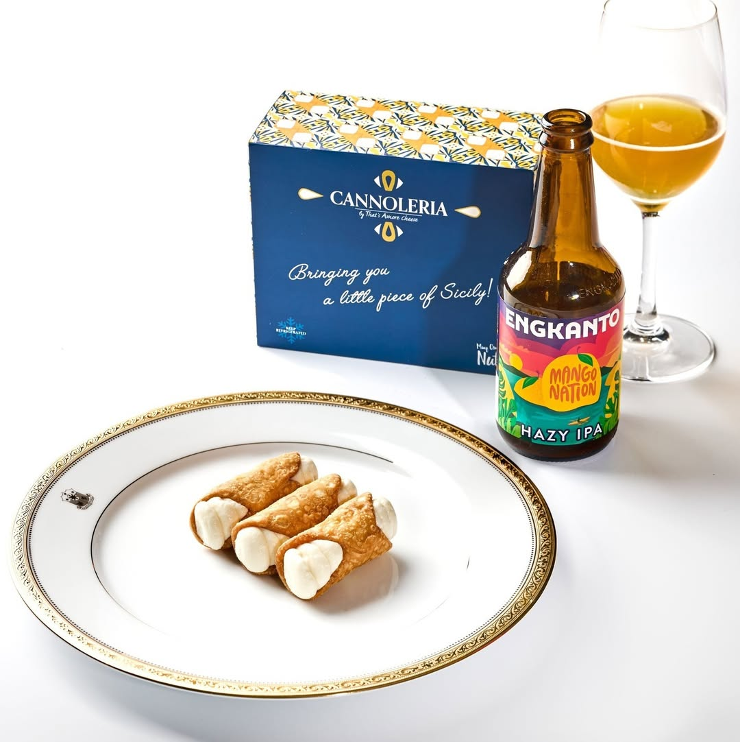 A plate of cannoli and a bottle of beerDescription automatically generated