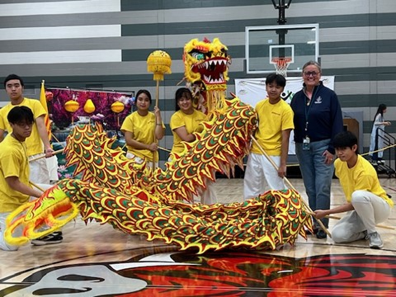 Dr. Reid with a group of students at the Community International Festival at the James Lee Community Center. 