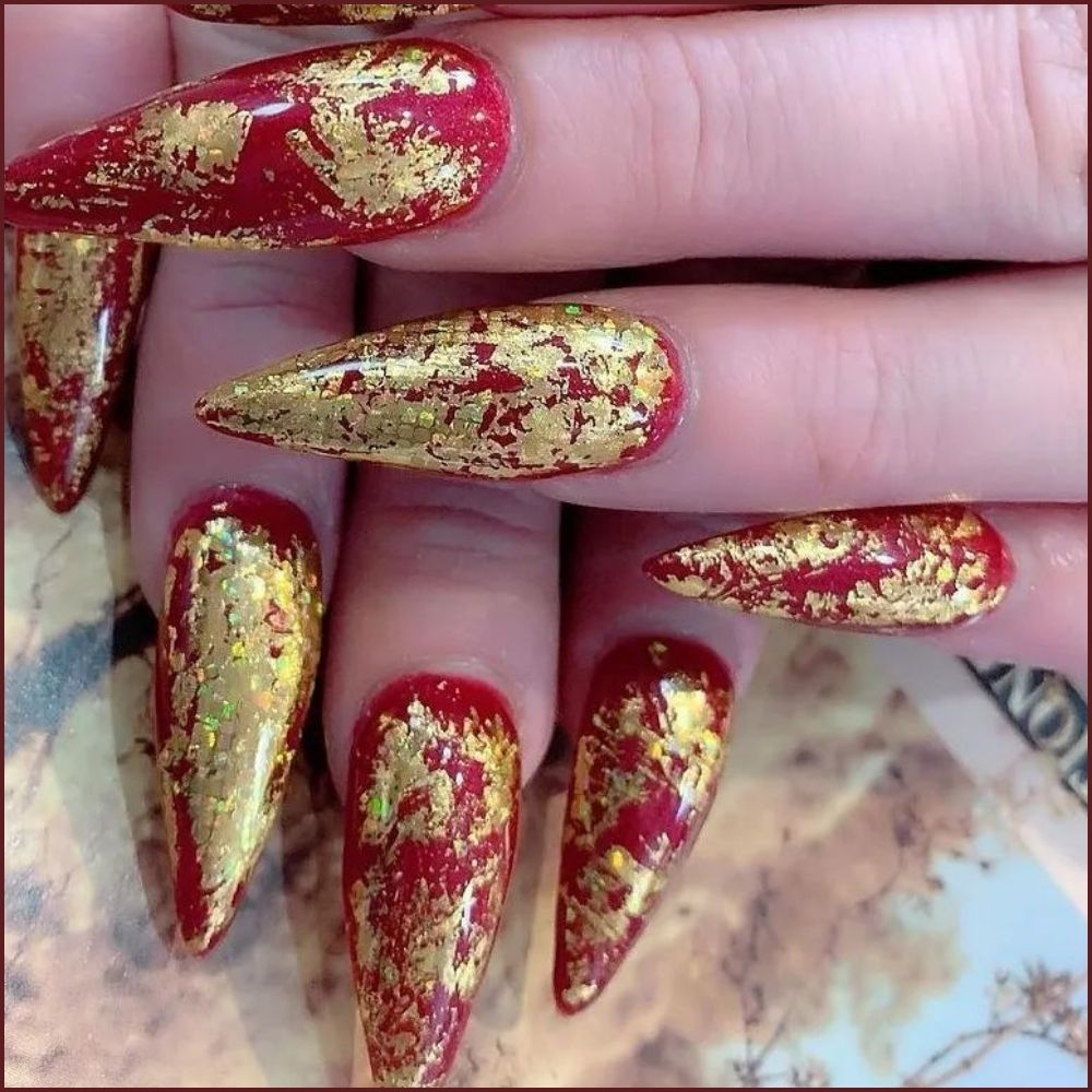 Close up of hands having Christmas red nails with Festive Red and Gold Stilettos