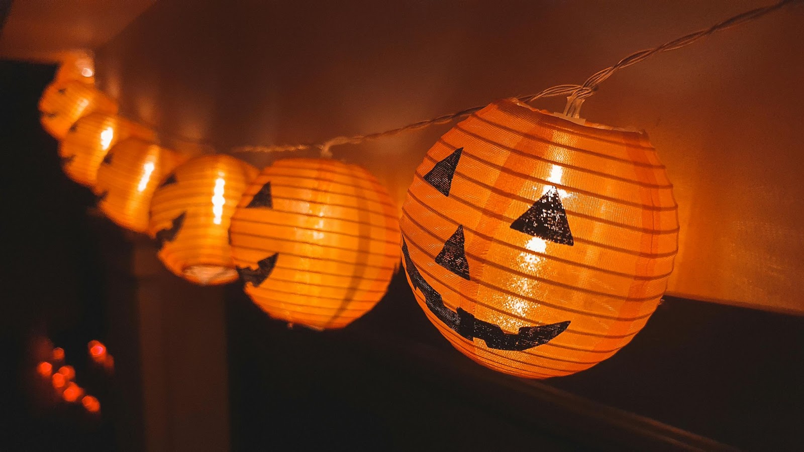 A string of lights made of paper jack-o-lanterns