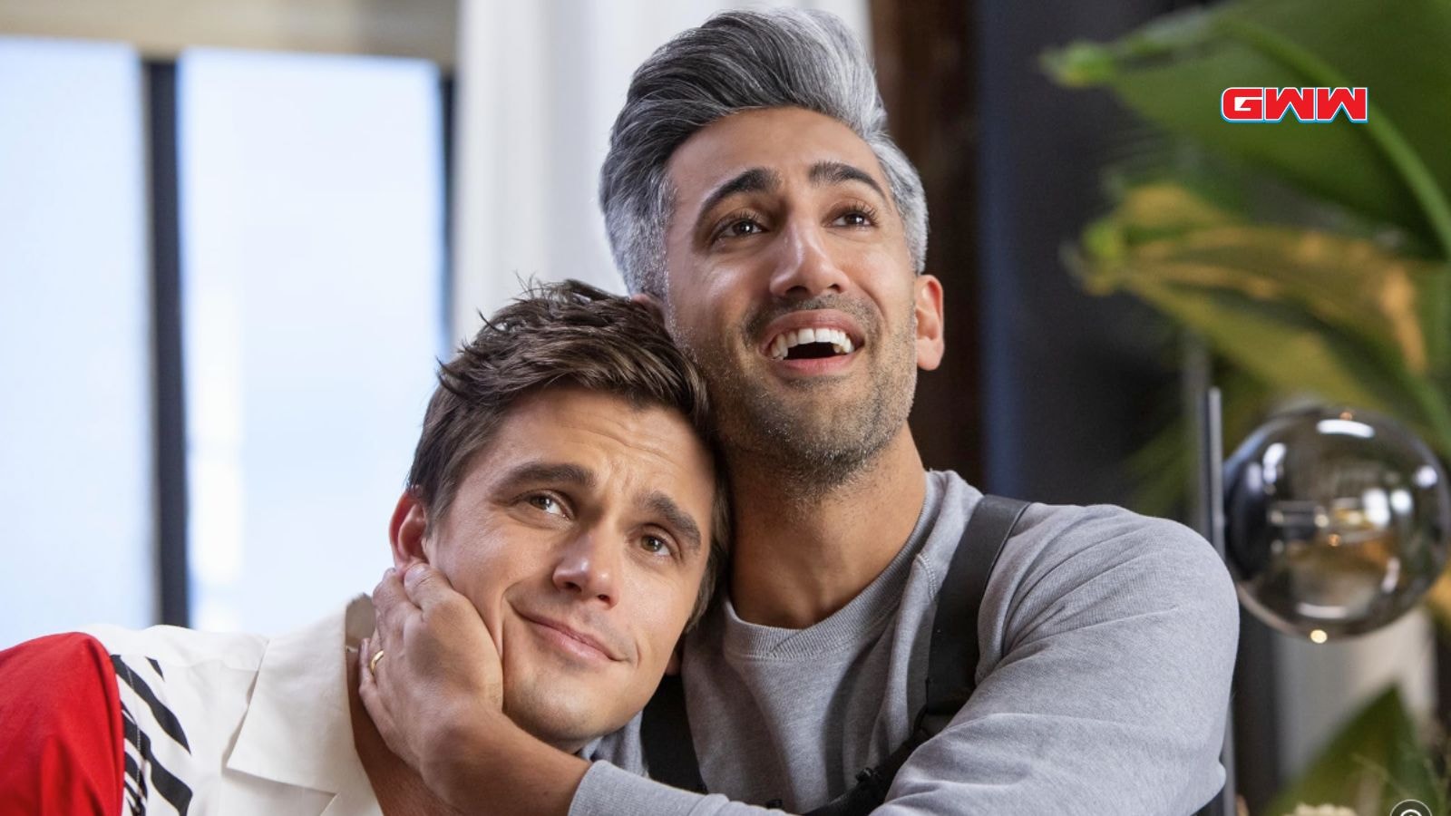 Tan France affectionately embracing Antoni Porowski in a warm moment.