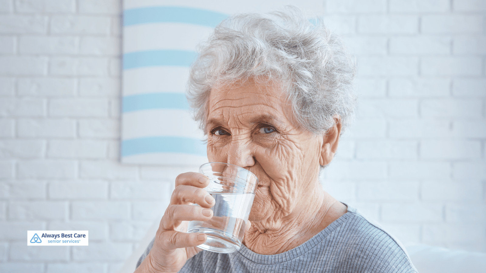 This is an image depicting a senior woman enjoying a glass of water