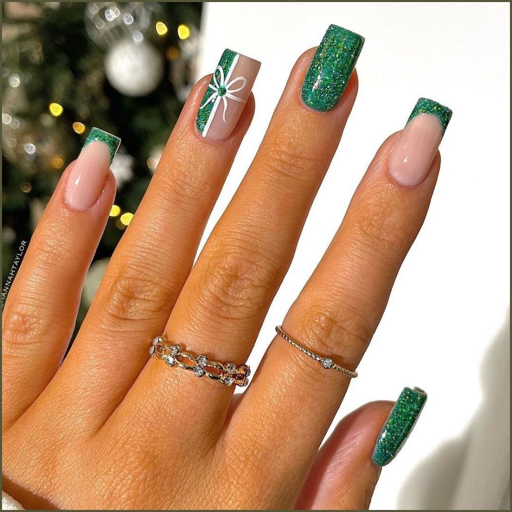 Close up of hands with Christmas Green Nails having  Green Glitter Gift Wrap