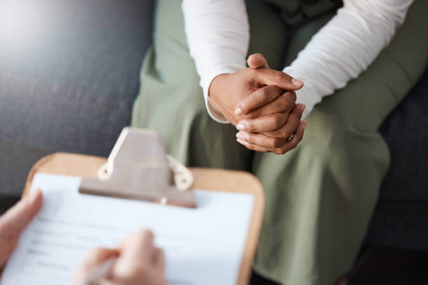 A healthcare professional providing a consultation to a person, discussing detox supplement options.