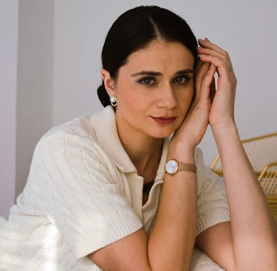 beautiful woman sat looking at camera