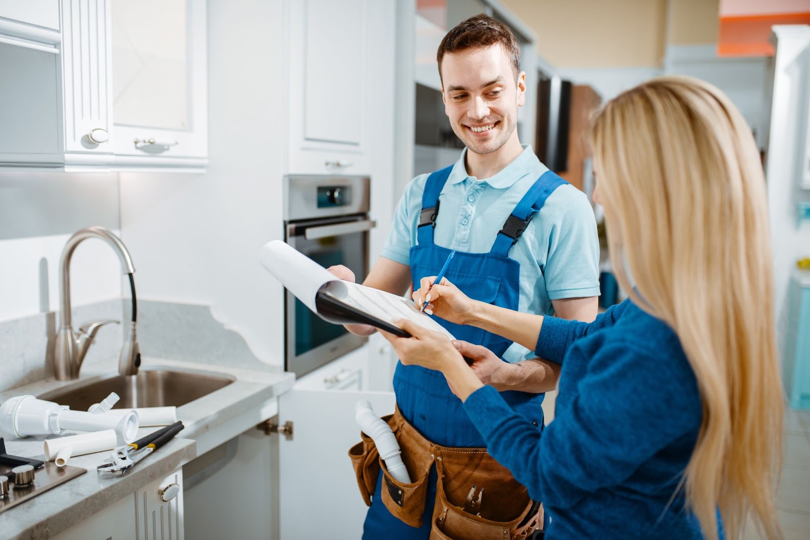 Happy plumber and client signing papers