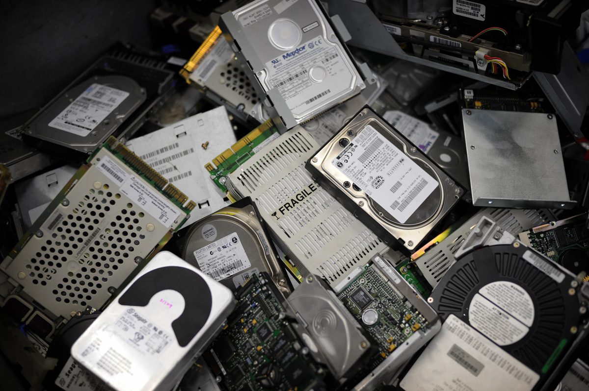 Steps for safely destroying a hard drive before recycling, including disassembly and data destruction.