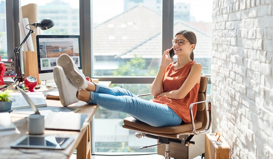 A girl talking on phone near her workspace