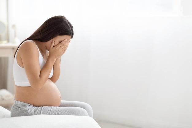 Premium Photo | Young pregnant woman feeling sad crying at home