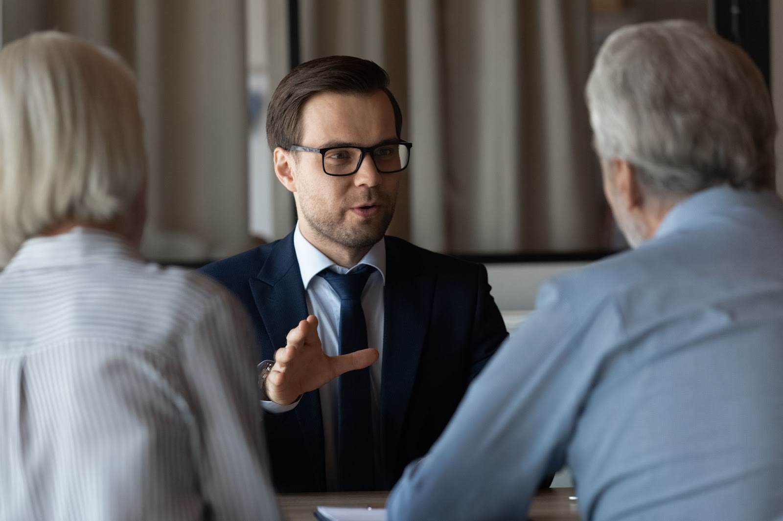 An elder law attorney provides legal advice to an older couple.