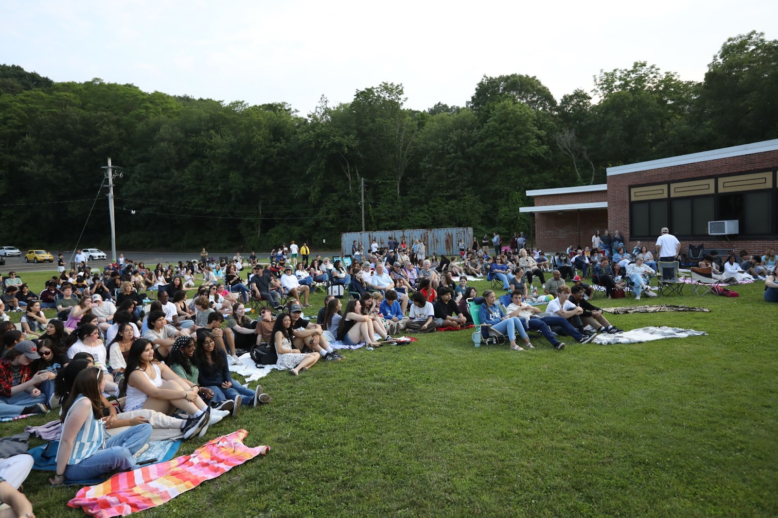 crowd listening to music outside on the lawn