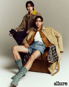 This  contain an image of Nam Yoon Su and   Park Jun Ho  sitting on a chair and one person is holding a handbag while the other man holds a purse