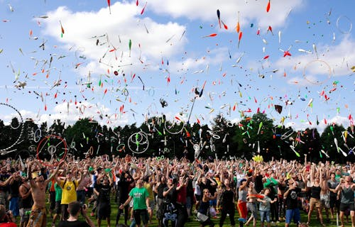 Free A lively crowd enjoying a colorful juggling event outdoors. Perfect for summer festival themes. Stock Photo