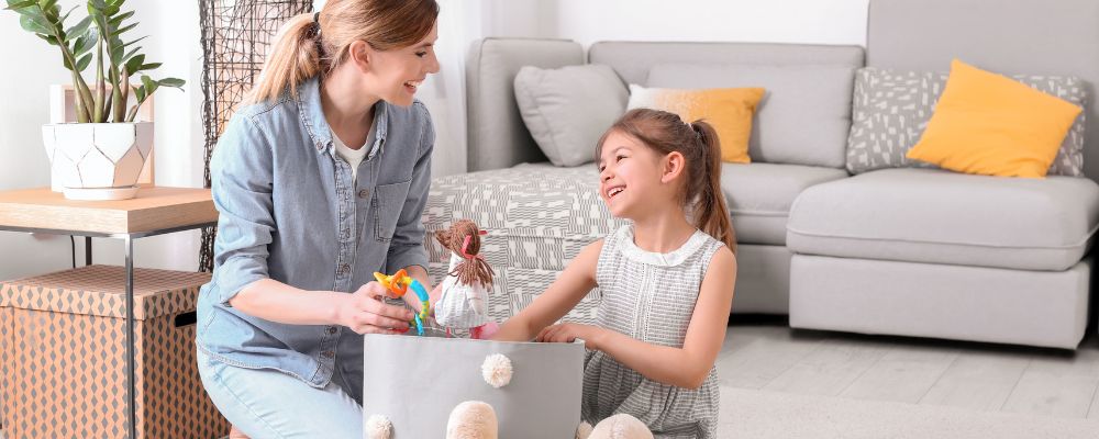 Parents picking up their children’s toys