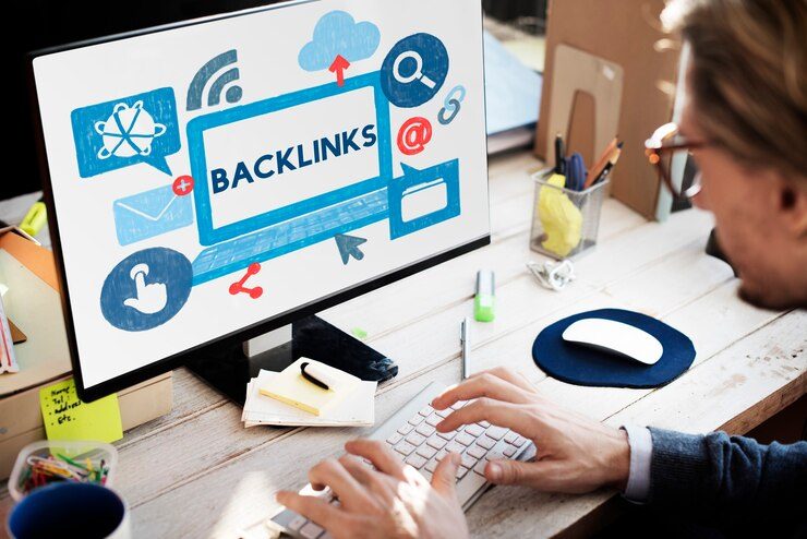 Man writing on computer screen with the word "Backlinks" displayed on it