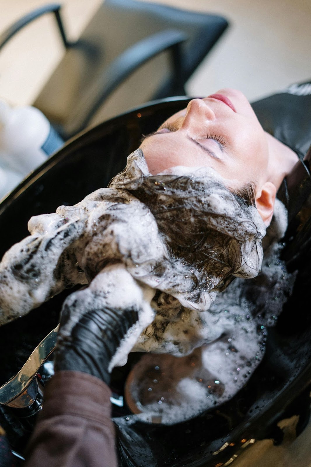 A Hair Stylist Washing Client's Hair