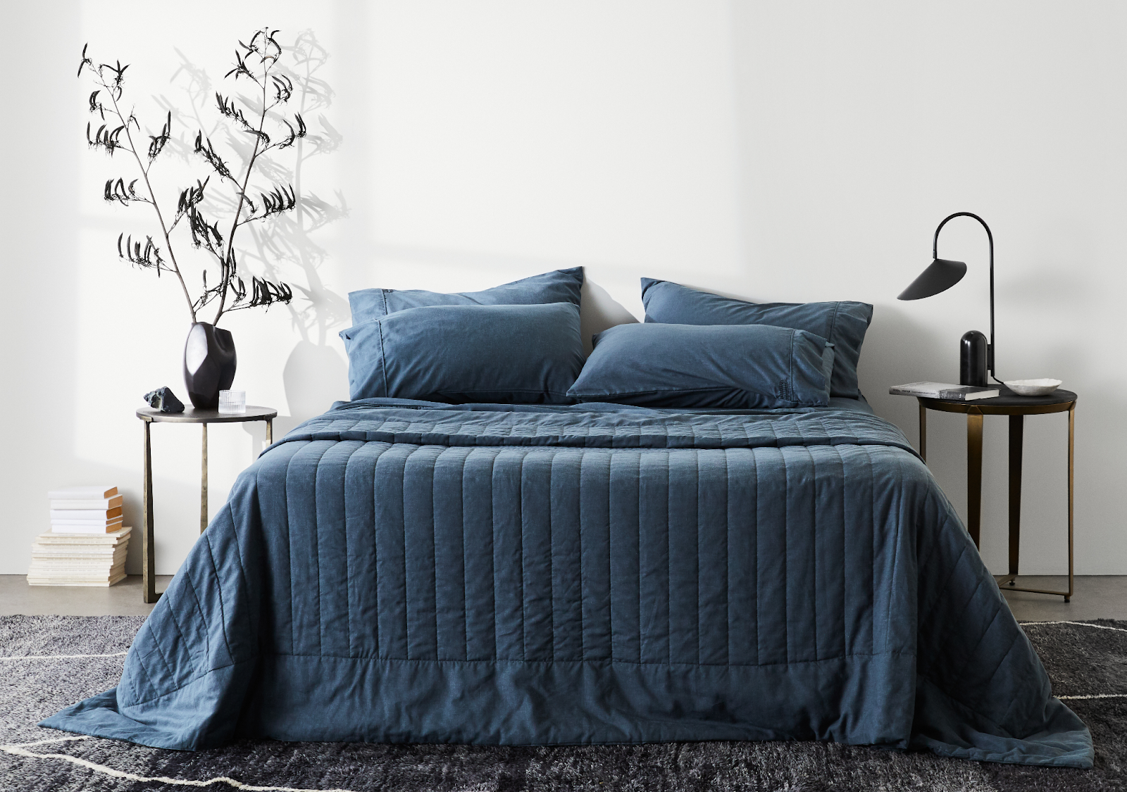 Modern bed dressed in ettitude CleanBamboo Hemp Linen+ Sheet Set in deep blue.