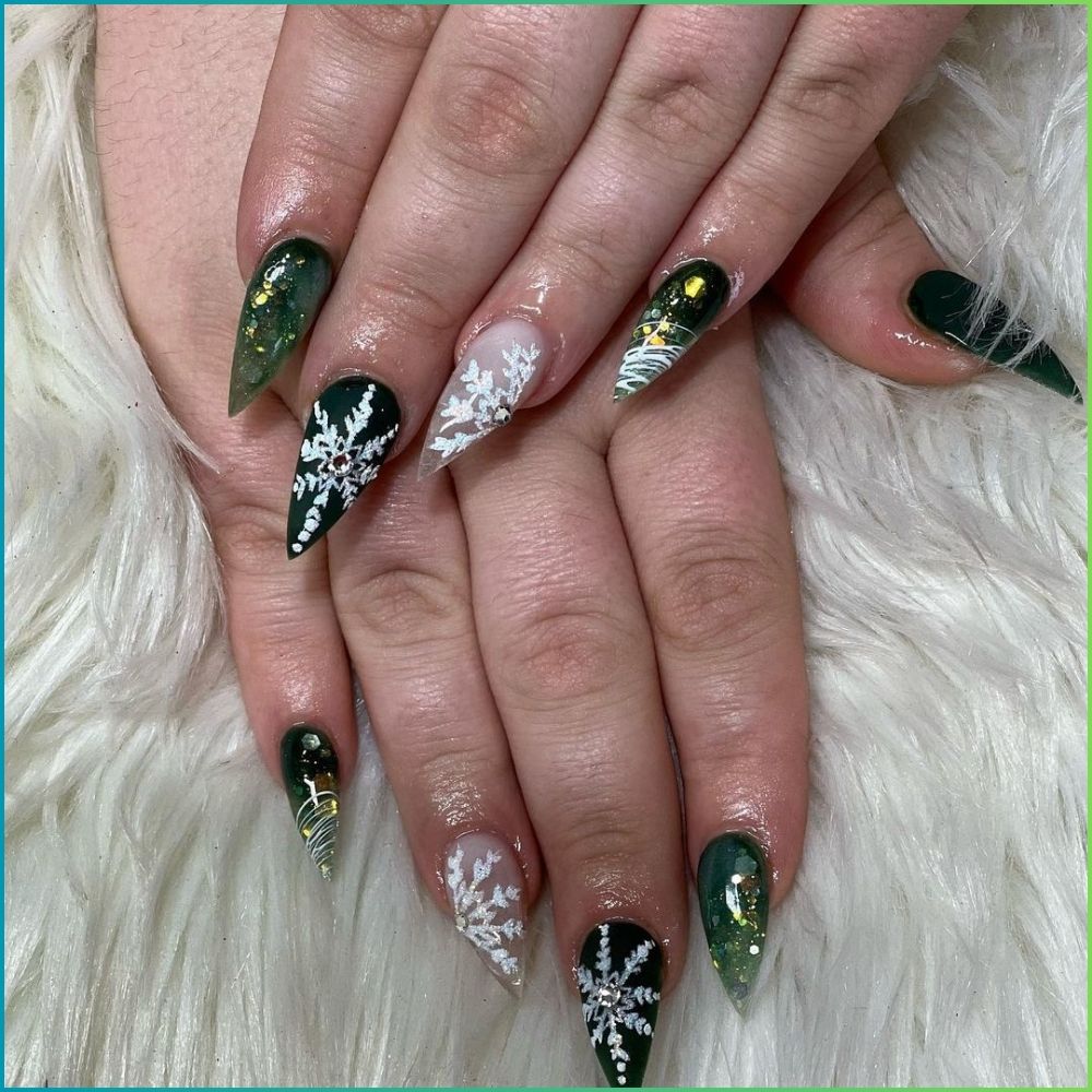 Close up of hands with Christmas Green Nails having  Snowflake Stiletto