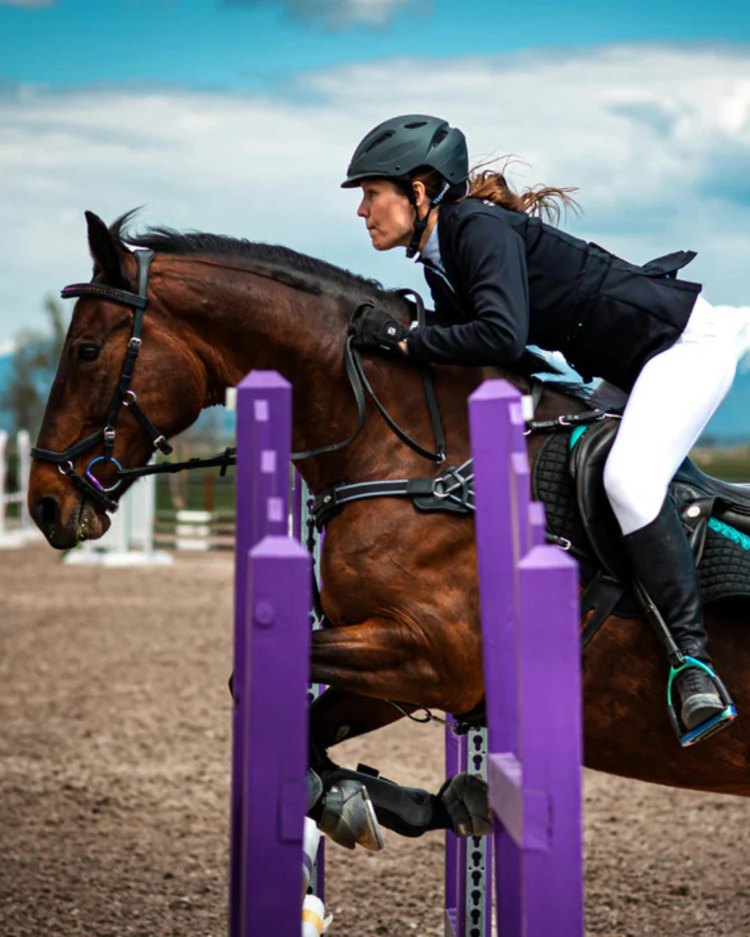 A woman riding a horse in competition