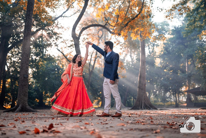 Romantic couple photoshoot in Coimbatore’s garden, dancing under the sunlight filtering through the trees