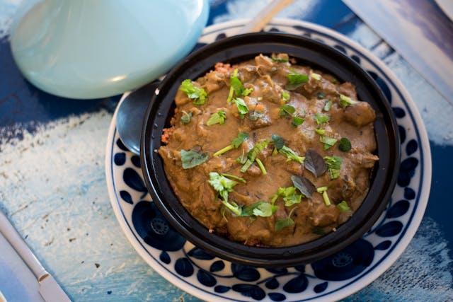 A bowl of food on a plate

Description automatically generated