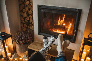 winter interior remodeling ideas to make your home warm and inviting living room fireplace with logs and foot rest custom built michigan