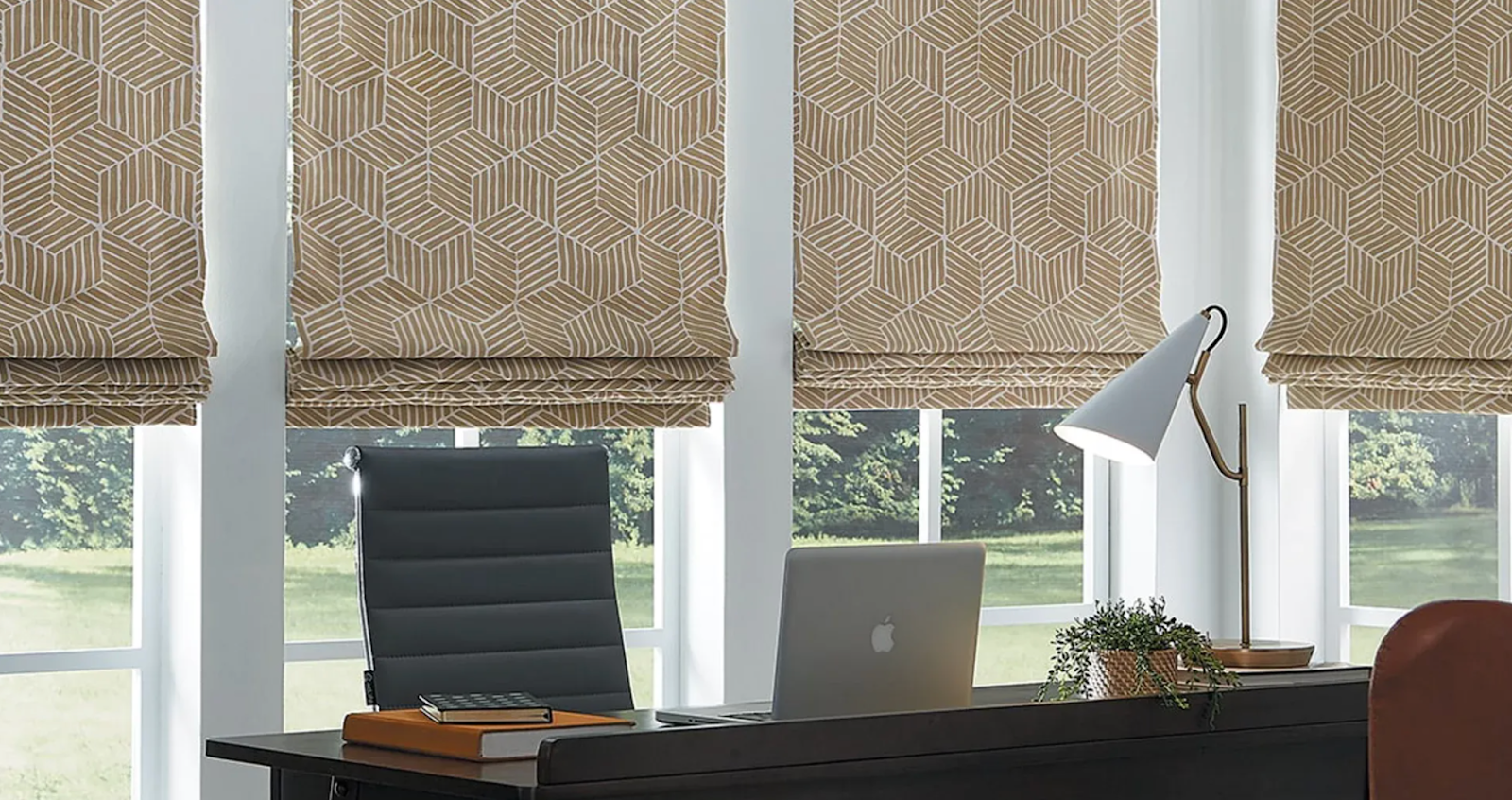 Carole Fabrics® Roman Shades frmo hunter douglas over windows of a home office