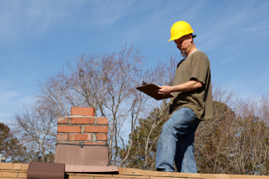 essential winterizing tips for your michigan home inspector checking brick chimney custom built okemos