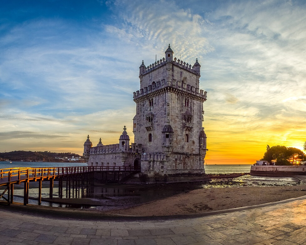 Belém Tower with a sunset in the background.